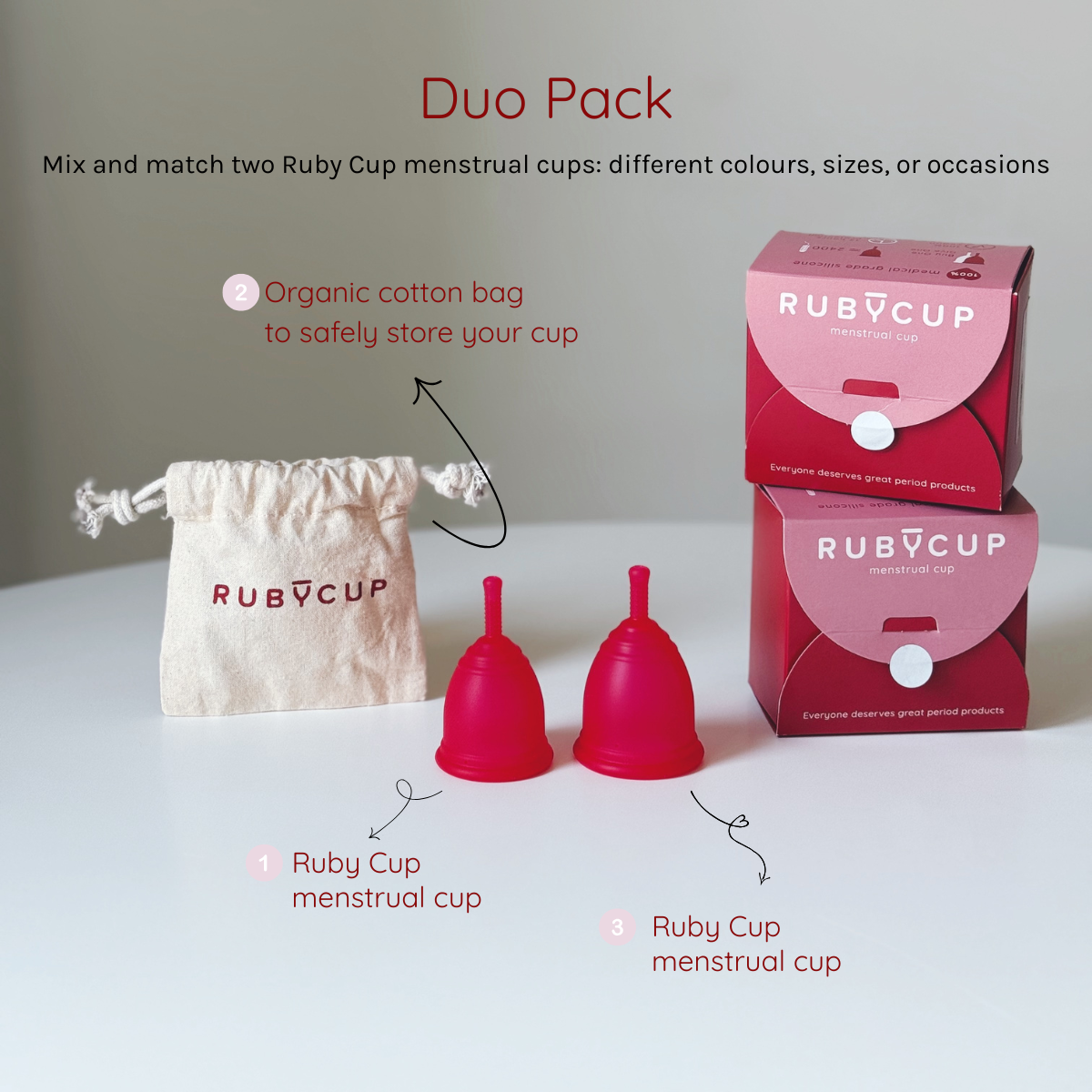 Ruby Cup menstrual cups in red with packaging and organic cotton bag