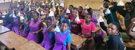 Girls holding their Ruby Cups that have been donated