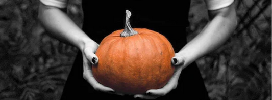 woman holding a Halloween pumpkin