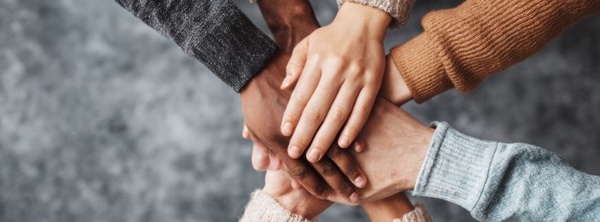 Close-up of women’s hands in a circle