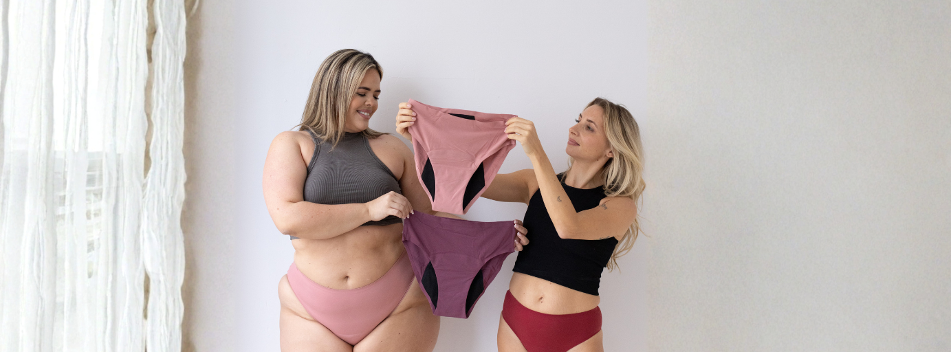 Two women holding Ruby Cup period pants