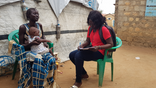 ACROSS Menstrual Hygiene Educator conducting a follow up survey with a Ruby Cup user in Mahad IDP Camp