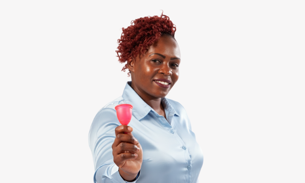 Woman holding a red Ruby Cup menstrual cup against a white background