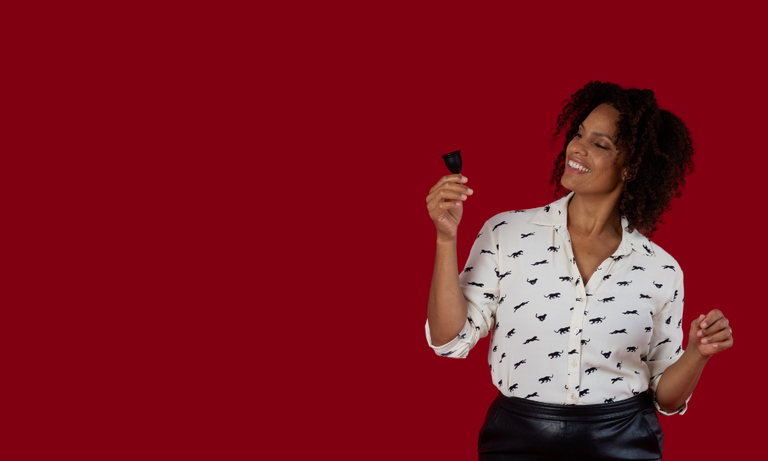 Woman holding a black Ruby Cup menstrual cup