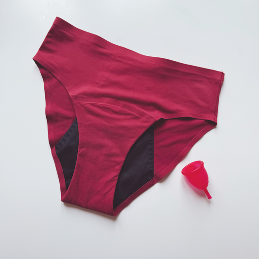 Red Ruby Cup period underwear and menstrual cup on a white background