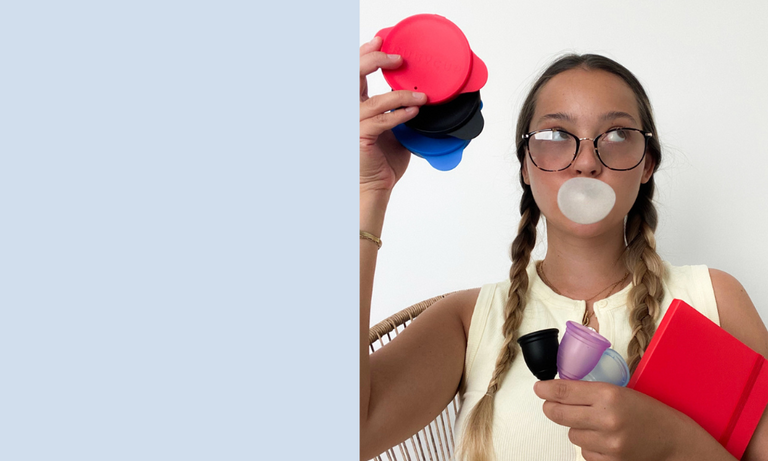 Two girls holding Ruby Cup menstrual cups and sterilisers